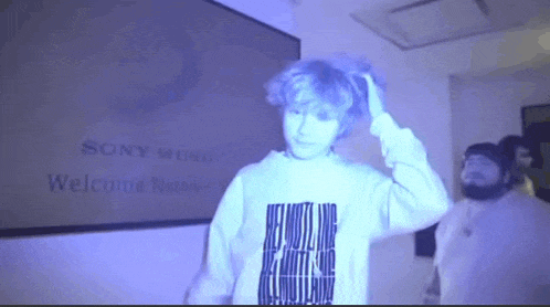 a man standing in front of a sign that says sony music welcome nurse