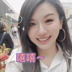a woman wearing hoop earrings and a white shirt smiles
