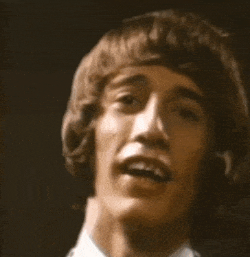 a close up of a man 's face in a dark room .