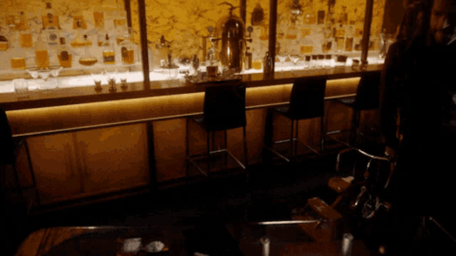 a bar with a lot of bottles on it including one that says ' tequila '