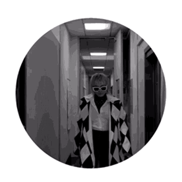a black and white photo of a woman wearing sunglasses