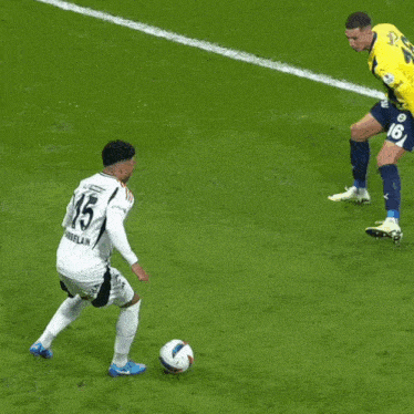 a soccer player wearing a yellow jersey with the number 2 on the back