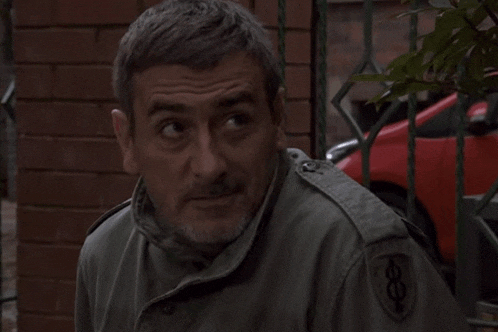 a man wearing a green jacket with a patch that says 8 on it