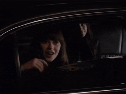 a person is looking out of a car window at a dark tunnel .