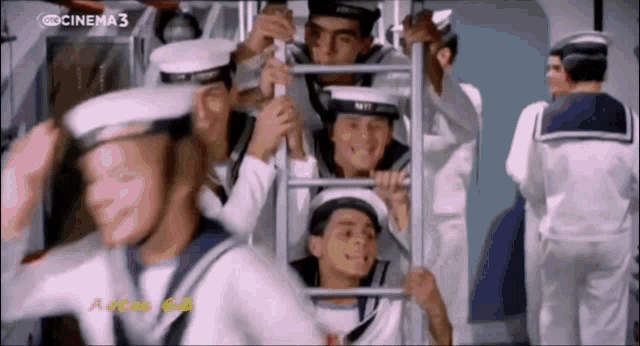 a group of men in sailor uniforms are standing in front of a screen that says cinema 3 on it