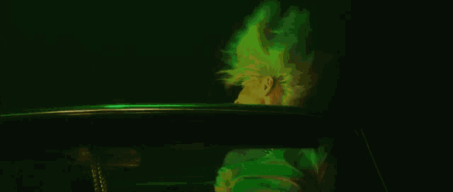 a woman with green hair is sitting in the back of a car .