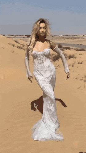 a woman in a white dress is standing in a desert with the words s ellascata o below her