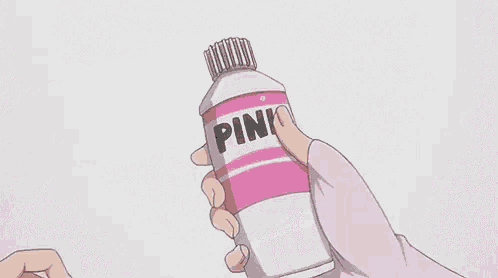 a person is holding a bottle of pink paint in their hand .