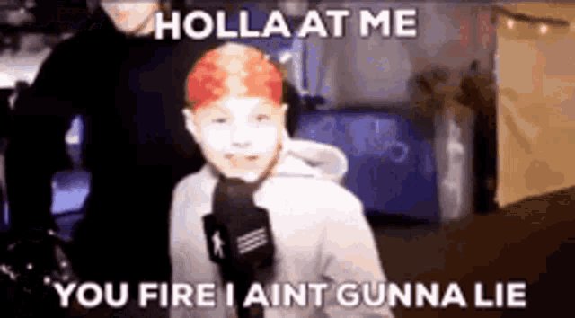 a young boy with red hair is holding a microphone and saying holla at me you fire i aint gunna lie