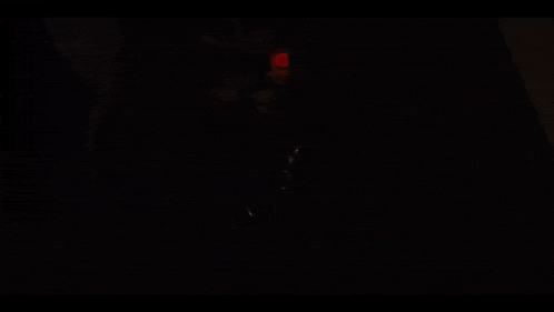 a close up of a toy with a red eye in the dark .