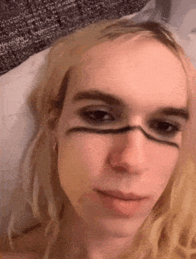 a close up of a woman 's face with makeup on her face