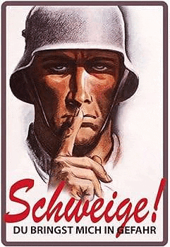 a soldier is holding his finger to his mouth .
