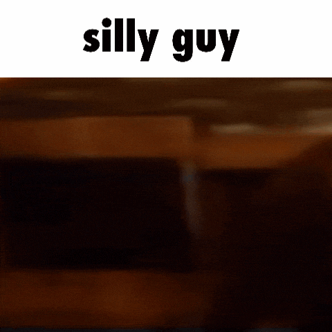 a close up of a person 's face with the words `` silly guy '' written above it .