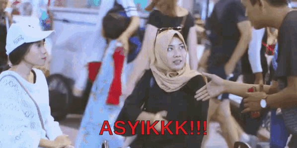 a woman in a hijab is talking to a man in a white hat and the words asylkkk !!! are visible