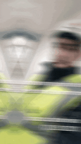 a blurry picture of a man in a yellow jacket