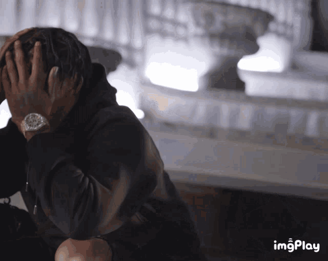 a person covering their face with their hands and the words imgplay below
