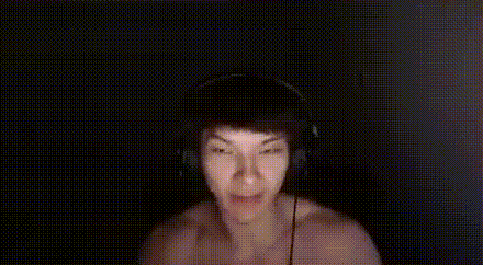 a person wearing headphones is holding a white box in front of their face ..