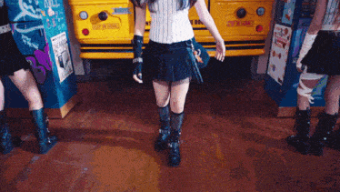 a girl in a black skirt is standing in front of a yellow school bus that says stop on school
