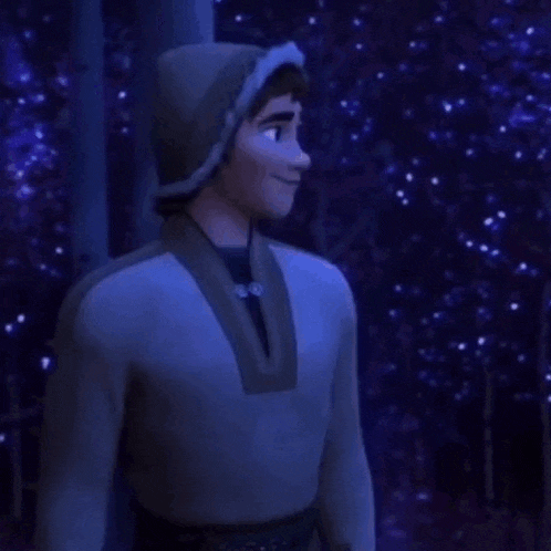a man in a hooded jacket is standing next to a tree in a forest .