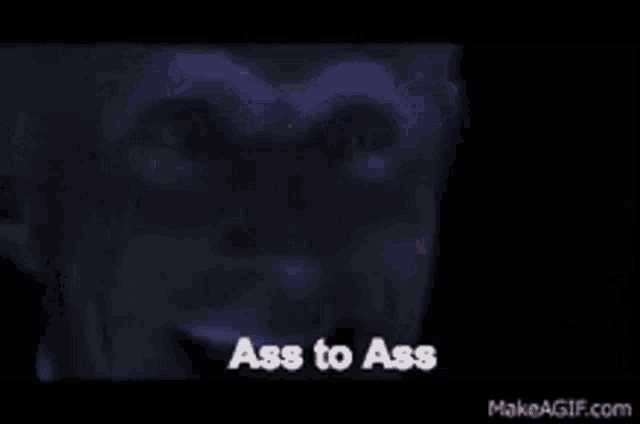 a close up of a man 's face with the words " ass to ass " on the screen