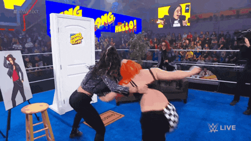 two women are wrestling in a wrestling ring with a sign that says welcome