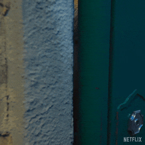 a woman peeking through a green door with netflix written on the bottom right