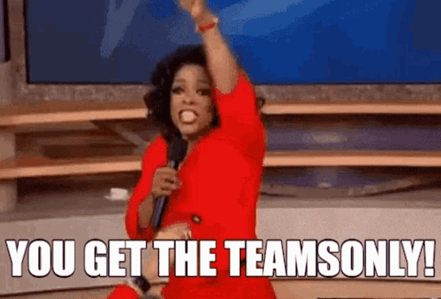 oprah winfrey is holding a microphone and saying `` you get the teams only '' .