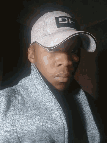 a man wearing a hat that has the letters gg on it