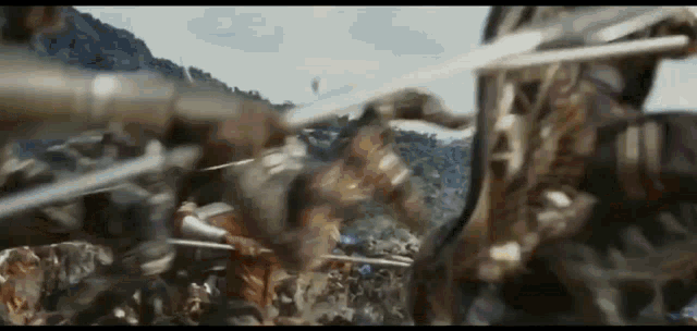 a group of soldiers are fighting each other in a battle with swords .