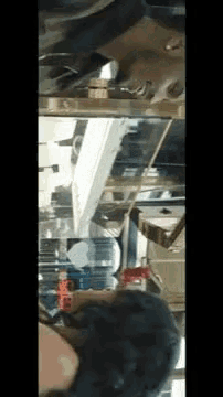 a woman is standing in front of a mirror looking down at herself