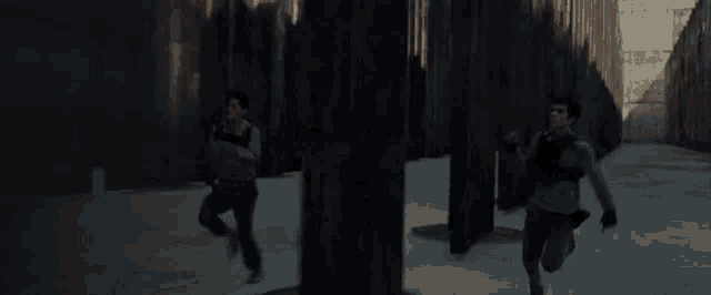 a person is running down a sidewalk in front of a wall .