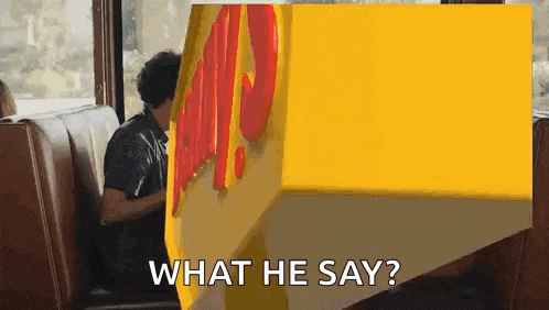 a man is sitting in a booth in front of a mcdonald 's sign and asking what he says .