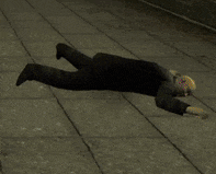 a man in a suit is laying on the ground with his arms outstretched