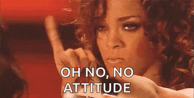 a woman with curly hair is making a funny face and giving a thumbs down sign .