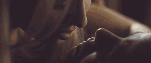 a close up of a woman kissing another woman 's neck .