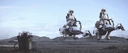 two storm trooper riders are flying over a field
