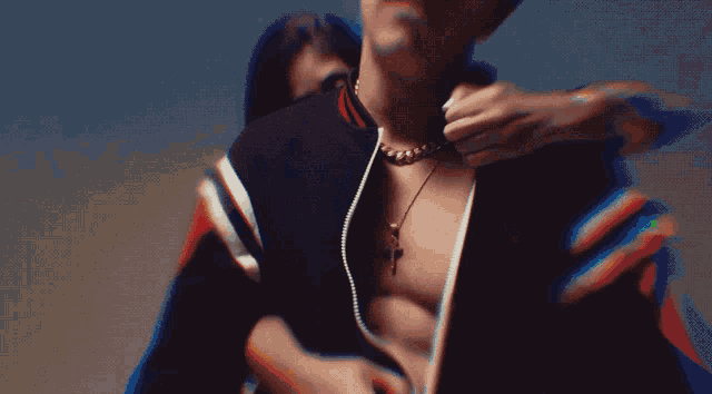 a close up of a man 's torso with a rainbow behind him