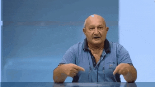 a man wearing a blue shirt that says castles on it