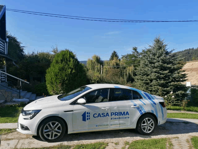 a white car with the word casa prima on the side