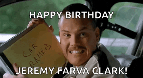 a man in a car holding a notebook that says happy birthday jeremy farva clark !