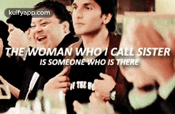 a group of men are sitting around a table with a caption that says " the woman who i call sister is someone who is there "
