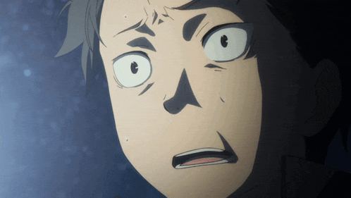 a close up of a man 's face with a surprised look on his face