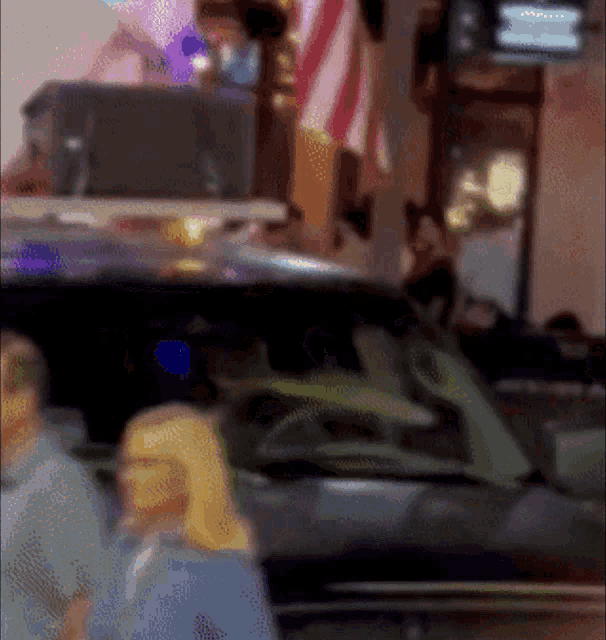 a blurry picture of a woman standing in front of a car