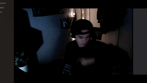 a man wearing headphones and a hat with the letters ea on it
