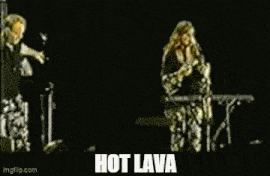 a person 's feet are walking on a yellow surface with the words `` hot lava '' written on it .