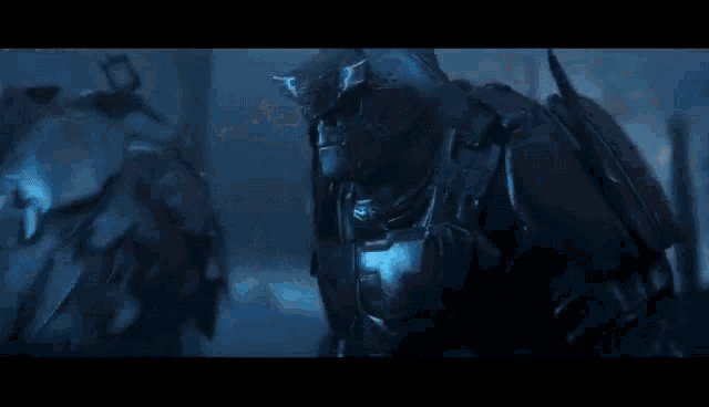 a group of soldiers in armor are standing next to each other in the dark .