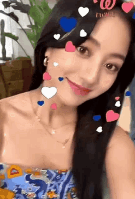 a woman is taking a selfie with hearts on her face