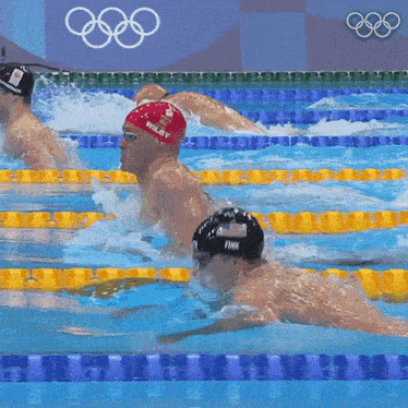 a swimmer wearing a red cap that says wilby is swimming in a pool