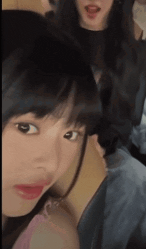 a close up of a woman 's face with her tongue hanging out