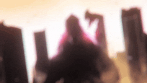 a blurry picture of a woman standing in front of a city skyline